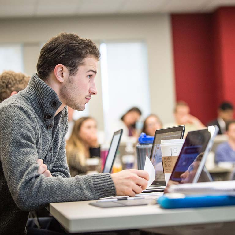 A student listens to a lecturer.