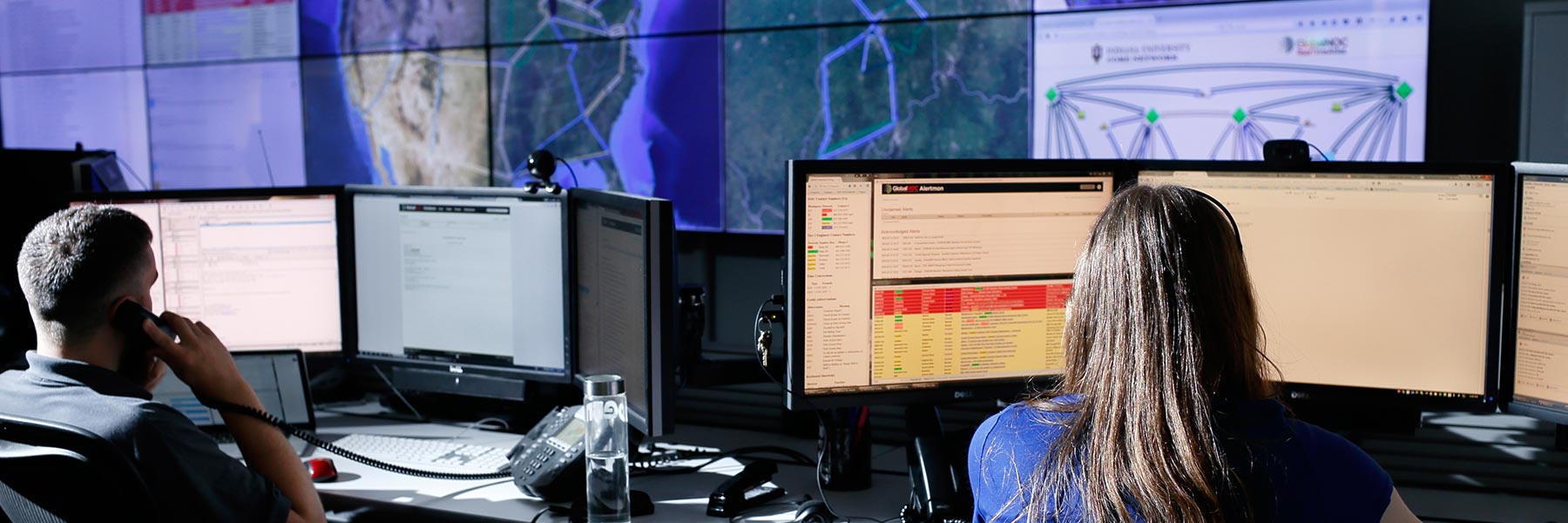 People look at computer screens in the Global Network Operations Center at IU.